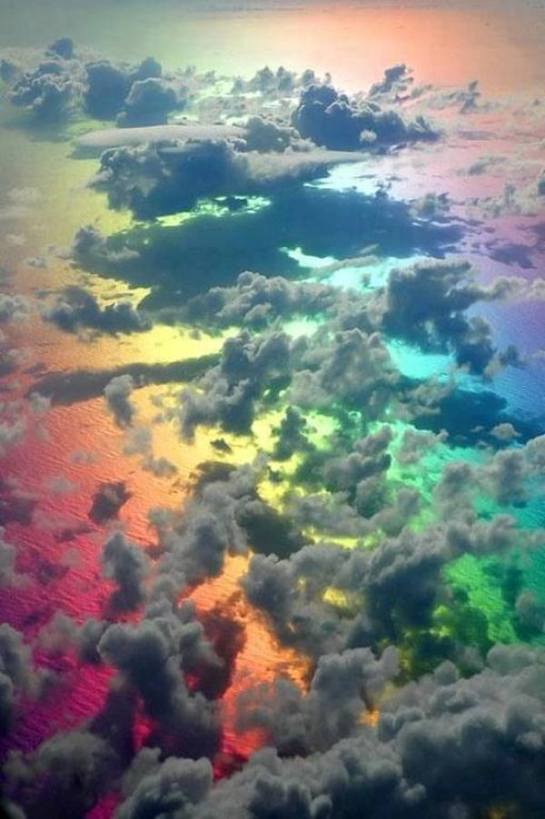 Amazing picture taken from a plane above the clouds and a rainbow